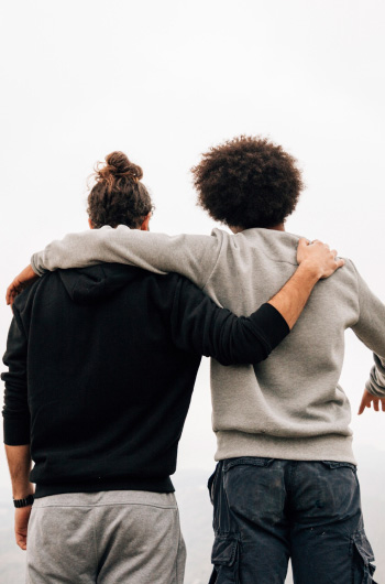 two lads embracing with their backs to the camera